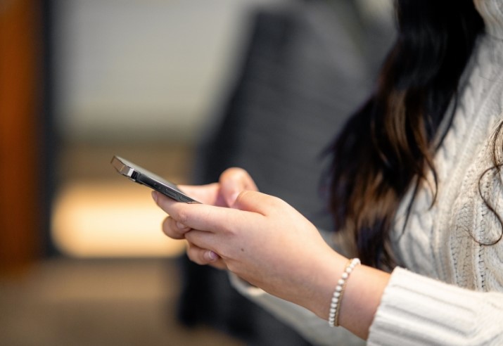Closeup of women using mobile phone